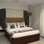 Calm, softly lit bedroom with a neatly made bed ready for a restful night