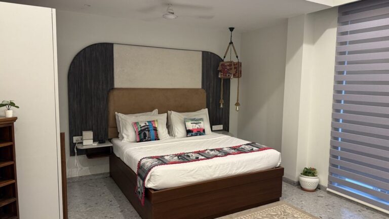 Calm, softly lit bedroom with a neatly made bed ready for a restful night